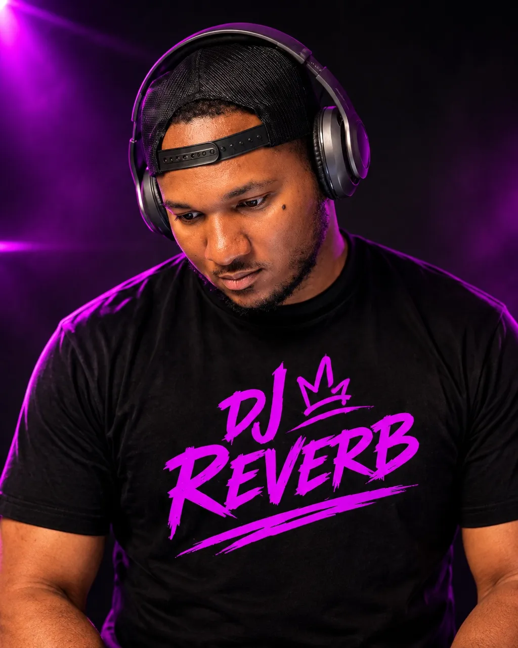 DJ Reverb, Isaiah Edmunds, in a branded black t-shirt for younger crowds, parties, and college events, against purple stage lighting